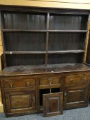 18TH CENTURY WELSH OAK DRESSER with later boarded and reduced rack above a base with three frieze