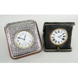 TWO GOLIATH WATCHES IN MOUNTED TRAVEL FRAMES, one with Asian white metal surround, 6cms diameter