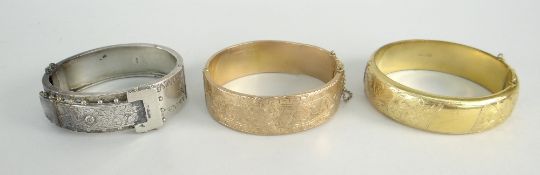 9CT YELLOW GOLD ENGRAVED BANGLE (21.1 grams), 9ct gold metal core bangle and a silver bangle of belt