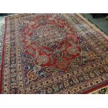 TABRIZ RUG with blue arabesque medallion and spandrels on red palmette ground, multiple borders