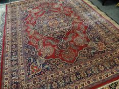 TABRIZ RUG with blue arabesque medallion and spandrels on red palmette ground, multiple borders