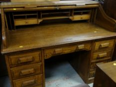 AMERICAN TYPE OAK TAMBOUR FRONTED BUREAU having fitted interior and nine drawers