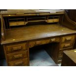 AMERICAN TYPE OAK TAMBOUR FRONTED BUREAU having fitted interior and nine drawers