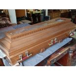 MODERN SIMULATED WALNUT CASKET with stylized faux metallic carry handles