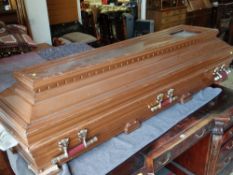 MODERN SIMULATED WALNUT CASKET with stylized faux metallic carry handles