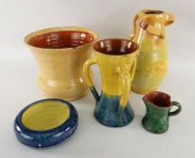 FIVE EWENNY POTTERY ITEMS including two three handled vases, cream jug, flared vase, circular