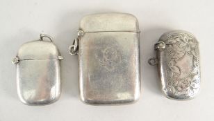 THREE SIMILAR SILVER VESTA CASES, one florally engraved, one with initials and one plain. All