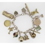 9CT YELLOW GOLD CURB LINK CHARM BRACELET having 9ct yellow gold heart shaped padlock. The assortment