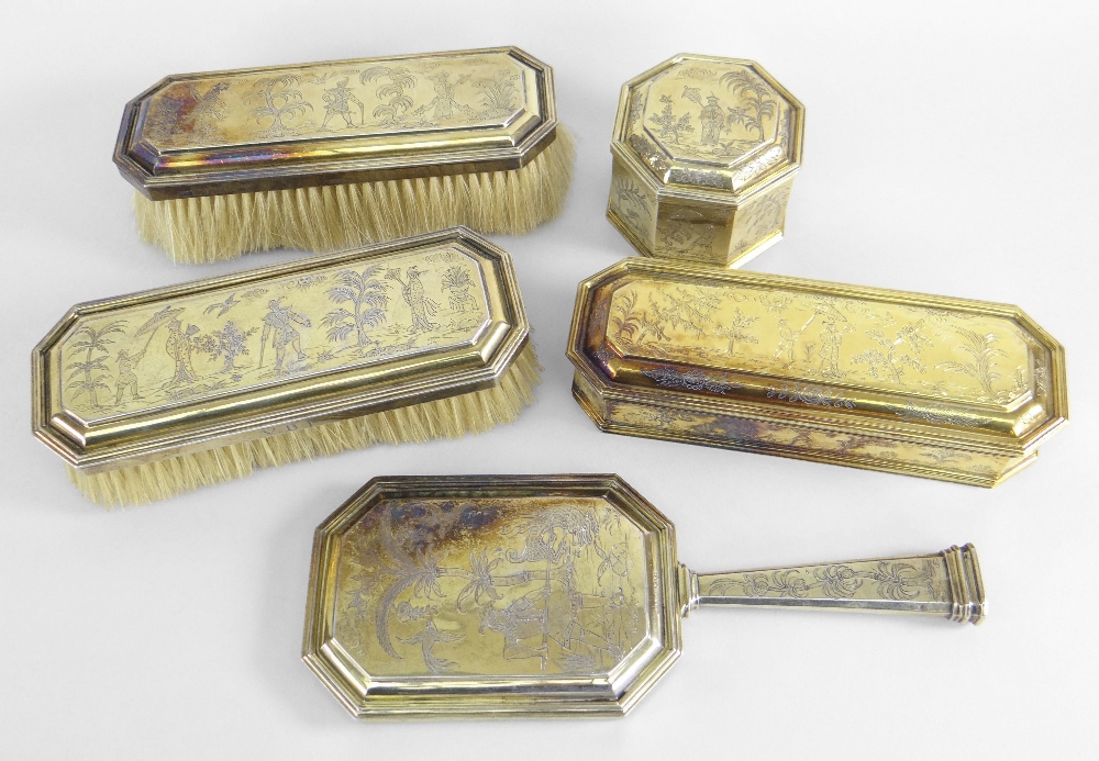 GEORGE V MATCHED FIVE-PIECE SILVER GILT DRESSING TABLE VANITY SET overall engraved in Chinoiserie