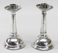 PAIR OF ARTS & CRAFTS SILVER CANDLESTICKS BY A E JONES, Birmingham 1925, planished details, 17cms