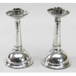 PAIR OF ARTS & CRAFTS SILVER CANDLESTICKS BY A E JONES, Birmingham 1925, planished details, 17cms