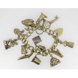 18CT GOLD CURB LINK CHARM BRACELET HAVING HEART SHAPED PADLOCK and an assortment of mainly 9ct