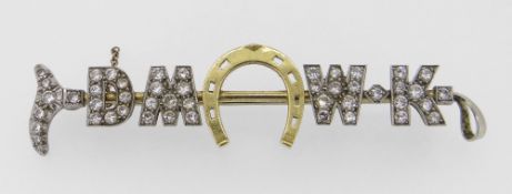 YELLOW & WHITE METAL DIAMOND ENCRUSTED BAR BROOCH in the form of a riding crop and horseshoe. The 47