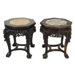 MATCHED PAIR OF CHINESE CARVED HARDWOOD OCTAGONAL STANDS, the tops with inset marble on four