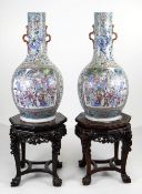 AN IMPRESSIVE PAIR OF CANTON FAMILLE ROSE PORCELAIN VASES, 19th Century, the narrow necks applied