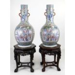 AN IMPRESSIVE PAIR OF CANTON FAMILLE ROSE PORCELAIN VASES, 19th Century, the narrow necks applied