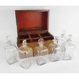 19TH CENTURY BURR WALNUT DECANTER BOX containing six gilt decorated Dutch decanters and stoppers,