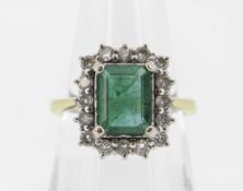 18CT YELLOW GOLD EMERALD & DIAMOND DRESS RING, the central emerald (7 x 9mms) surrounded by
