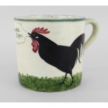 A LLANELLY POTTERY MUG painted with a single black cock crowing on grass with speech bubble from