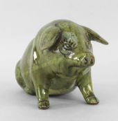 EWENNY POTTERY SEATED PIG with integral rear legs and separate front, mottled green glaze, sgraffito