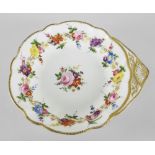 A NANTGARW PORCELAIN SHELL SHAPED DISH decorated with a continuous band of flowers to the border and