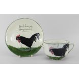 A LLANELLY POTTERY TEA CUP & SAUCER painted with single black strutting cock to each element, and