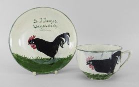 A LLANELLY POTTERY TEA CUP & SAUCER painted with single black strutting cock to each element, and