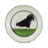A LLANELLY POTTERY PLATE painted with single strutting black cock on grass, 20cms diam Condition