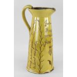 EWENNY POTTERY SLIPWARE WATER JUG of tapered form with loop handle, in mustard glaze, naturalistic