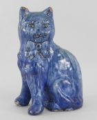 EWENNY POTTERY MODEL OF A SEATED CAT in mottled blue glaze, separate front legs, incised