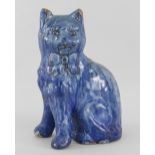 EWENNY POTTERY MODEL OF A SEATED CAT in mottled blue glaze, separate front legs, incised