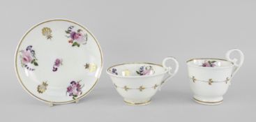 A NANTGARW PORCELAIN TRIO the two footed cups having elevated loop handles, each element painted