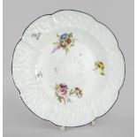 A NANTGARW PORCELAIN CRUCIFORM PLATE WITH DAISY MOULDING decorated with sprays of flowers within the
