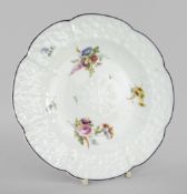 A NANTGARW PORCELAIN CRUCIFORM PLATE WITH DAISY MOULDING decorated with sprays of flowers within the