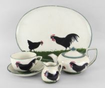 A LLANELLY POTTERY FOUR PIECE CABARET TEA SET painted with Black Cocks strutting on grass,