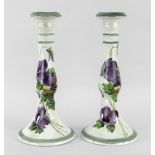 A RARE PAIR OF LLANELLY CANDLESTICKS with circular bases and decorated with pansies, stencilled