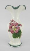 A SMALL LLANELLY POTTERY SPILL VASE with faceted body and shaped neck, painted with briar-roses,