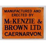 ENAMEL SIGN FOR MCKENZIE & BROWN LTD CAERNARVON orange ground with blue lettering, 23 x 31cms