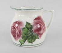 A LLANELLY POTTERY MILK JUG painted with tea-roses and leaves, stencilled Llanelly to base, 8cms