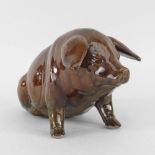 EWENNY POTTERY MODEL OF A SEATED PIG in brown mottled glaze, incised decoration, inscribed to