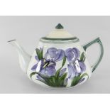 A LLANELLY POTTERY TEAPOT painted with purple irises, stencilled Llanelly to base, 21cms spout to