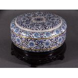 20TH CENTURY CLOISONNE ENAMEL CIRCULAR BOX & COVER on a carved hardwood stand decorated in blue