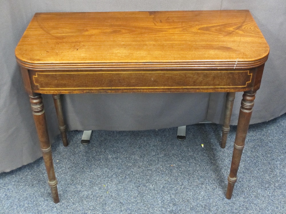 REGENCY MAHOGANY FOLD-OVER TEA TABLE with boxwood string decoration on turned tapering supports,