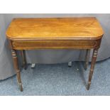 REGENCY MAHOGANY FOLD-OVER TEA TABLE with boxwood string decoration on turned tapering supports,