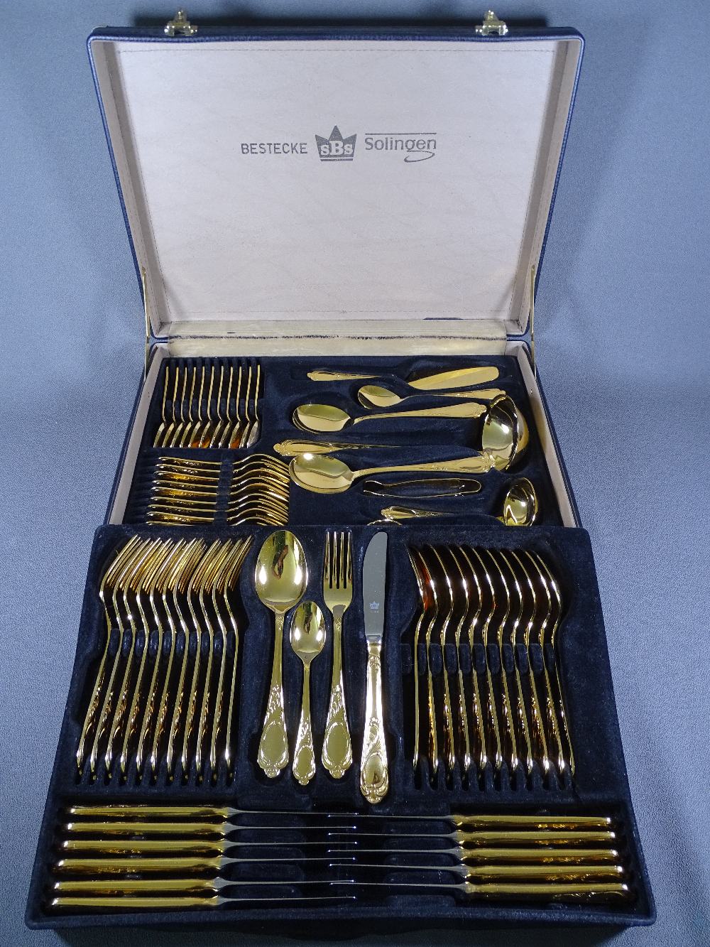 BESTECKE SOLINGN SBS 23/24 KARAT GOLD PLATED CUTLERY in fitted attache type case, 70 pieces, in