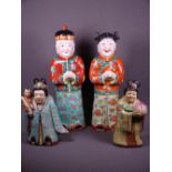 ORIENTAL POTTERY FIGURINES, two pairs including a boy and girl in colourful traditional costume,