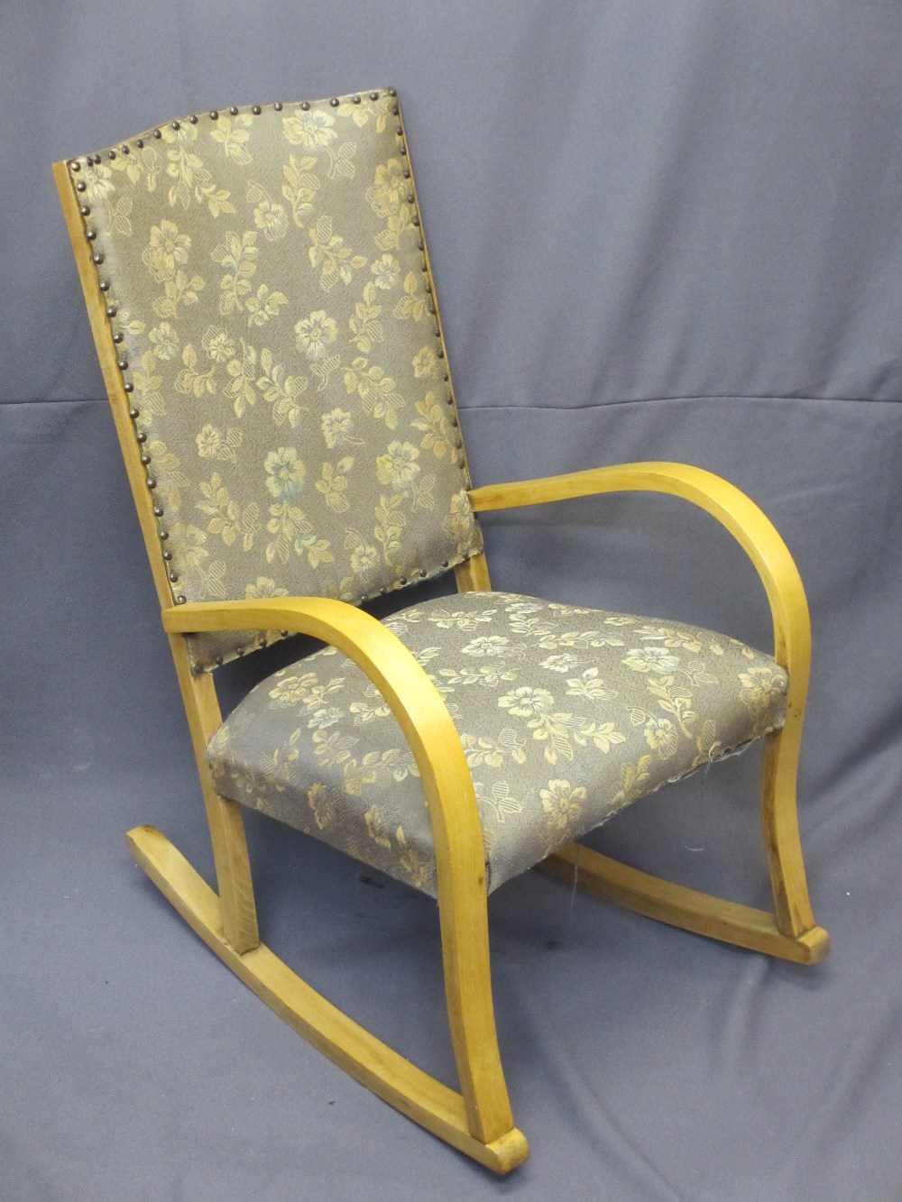 VINTAGE STYLE LIGHTWOOD ROCKING ARMCHAIR with studded edge upholstery to the back, 87cms H, 54.