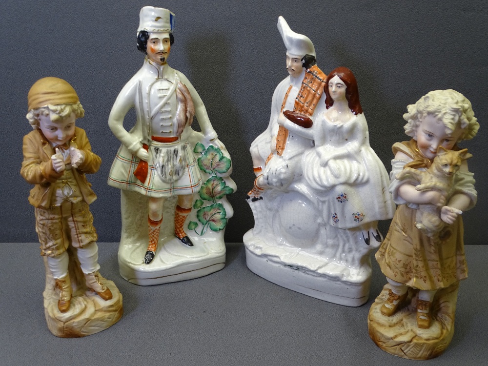 TWO STAFFORDSHIRE FLATBACKS and a pair of biscuit porcelain figurines of a young boy and girl