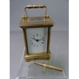 FRENCH MINIATURE BRASS CARRIAGE CLOCK, white enamel dial set with Roman numerals, key included,