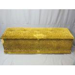 ANTIQUE PINE BLANKET BOX upholstered and with lined interior on modern castors, 47cms H overall,